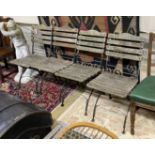 A set of four wrought iron slatted wood garden chairs