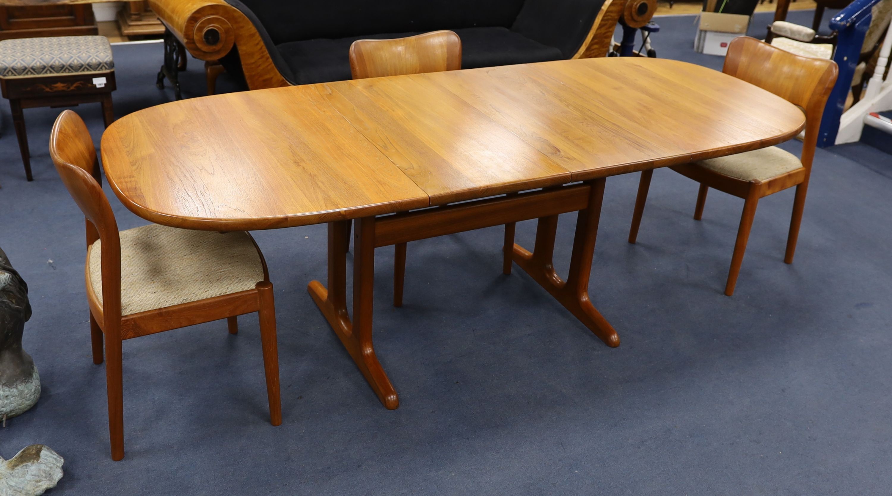 Mid century design. A Niels Koeford Danish teak extending dining table and four chairs, 222cm