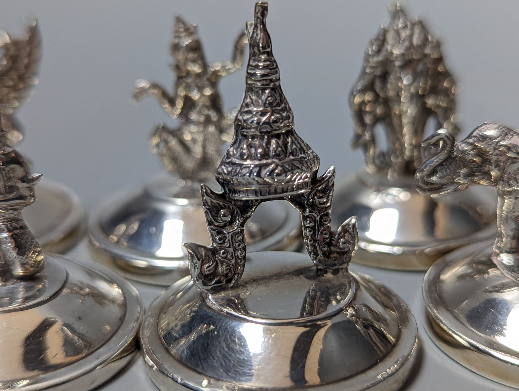 Sixteen assorted Siamese sterling mounted menu holders, modelled with figures, elephant, etc. - Image 11 of 17