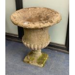 A reconstituted stone fluted campana shaped garden urn, diameter 62cm, height 70cm on square plinth