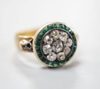 A George V 22ct gold emerald? and diamond set circular cluster ring, the shank with engraved