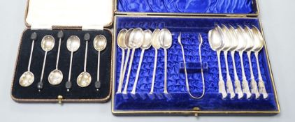 A cased set of six silver bean end coffee spoons, two other sets of six teaspoons and a pair of