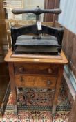 A Victorian cast iron book press on mahogany stand, marked Waterlow & Son, London, width 55cm, depth