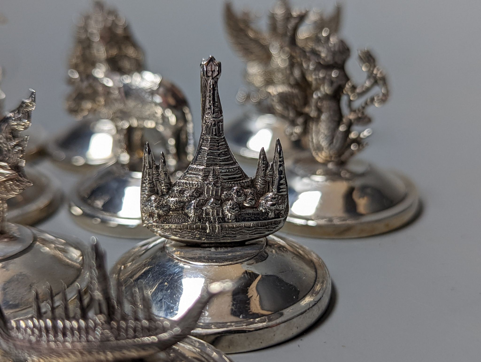 Sixteen assorted Siamese sterling mounted menu holders, modelled with figures, elephant, etc. - Image 5 of 17