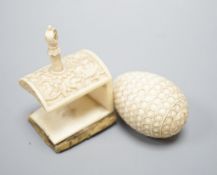 Ivory egg-shaped thread storage case and carved ivory needle-worker's table clamp,clamp, 6 cms