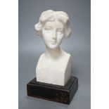 An alabaster head of a woman on plinth 25cm