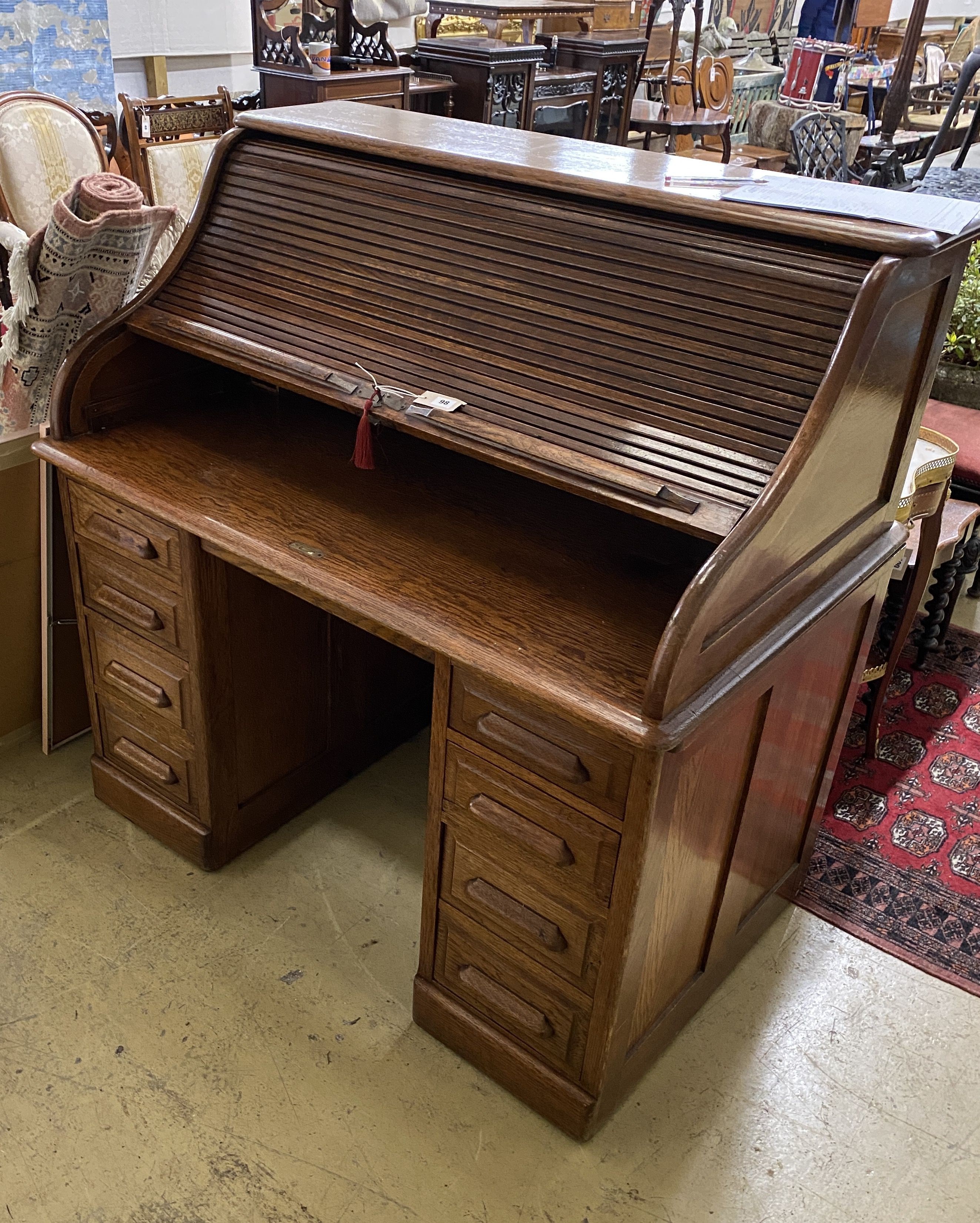 An early 20th century oak roll top desk with 'S' shaped tambour, width 122cm, depth 78cm, height