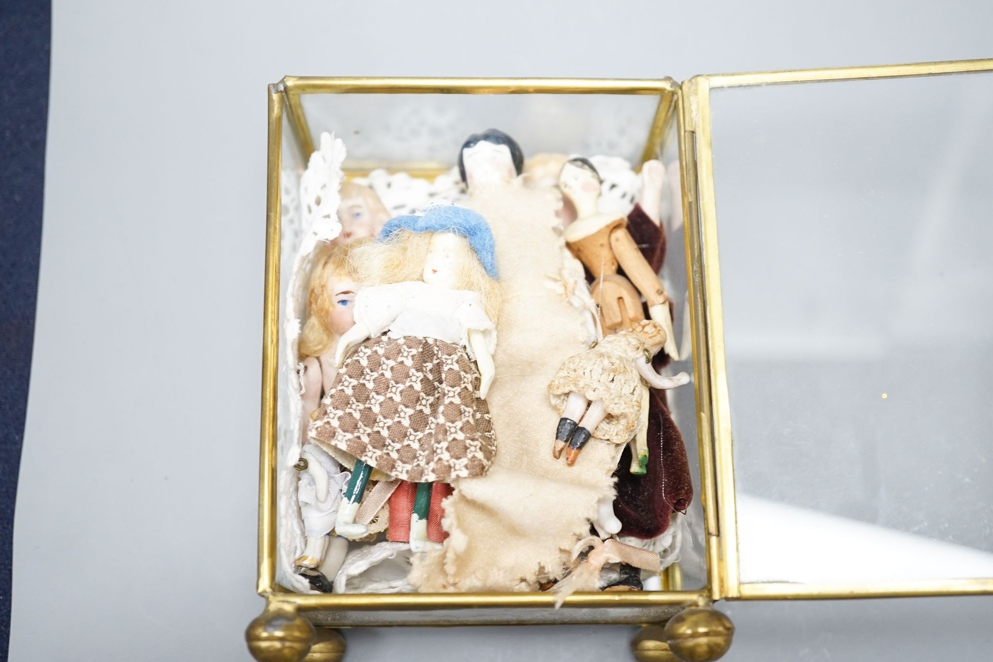 A collection of miniature bisque dolls and another larger doll in a wooden cradle, 11 dolls in - Image 8 of 8