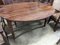 A 19th century French fruitwood circular dropleaf dining table, length 145cm extended, width