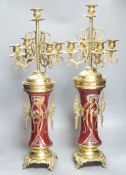A pair of large brass and ceramic mounted candelabra,64.5 cms high.
