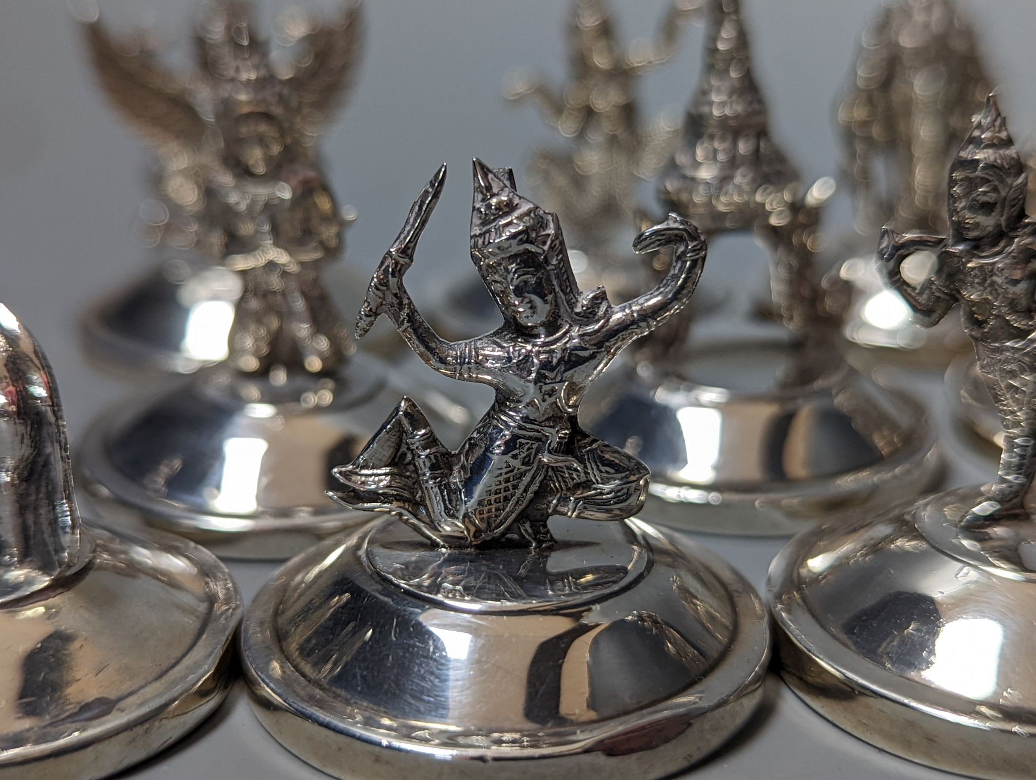 Sixteen assorted Siamese sterling mounted menu holders, modelled with figures, elephant, etc. - Image 7 of 17