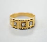 An 18ct and gypsy set three stone diamond ring, size M, gross 3.7 grams.