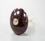 A yellow metal, foil backed cabochon garnet and diamond set oval dress ring, size P/Q, gross 11.1