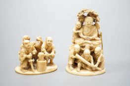 Two Japanese ivory okimono-netsuke of Buddha and attendants and a group of artisans, Meiji period,