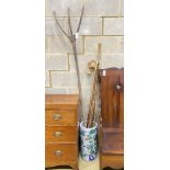Four assorted walking sticks and canes, a primitive wood rake and a Chinese stick stand