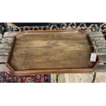 An Edwardian octagonal oak twin handled tray, length 62cm, depth 40cm