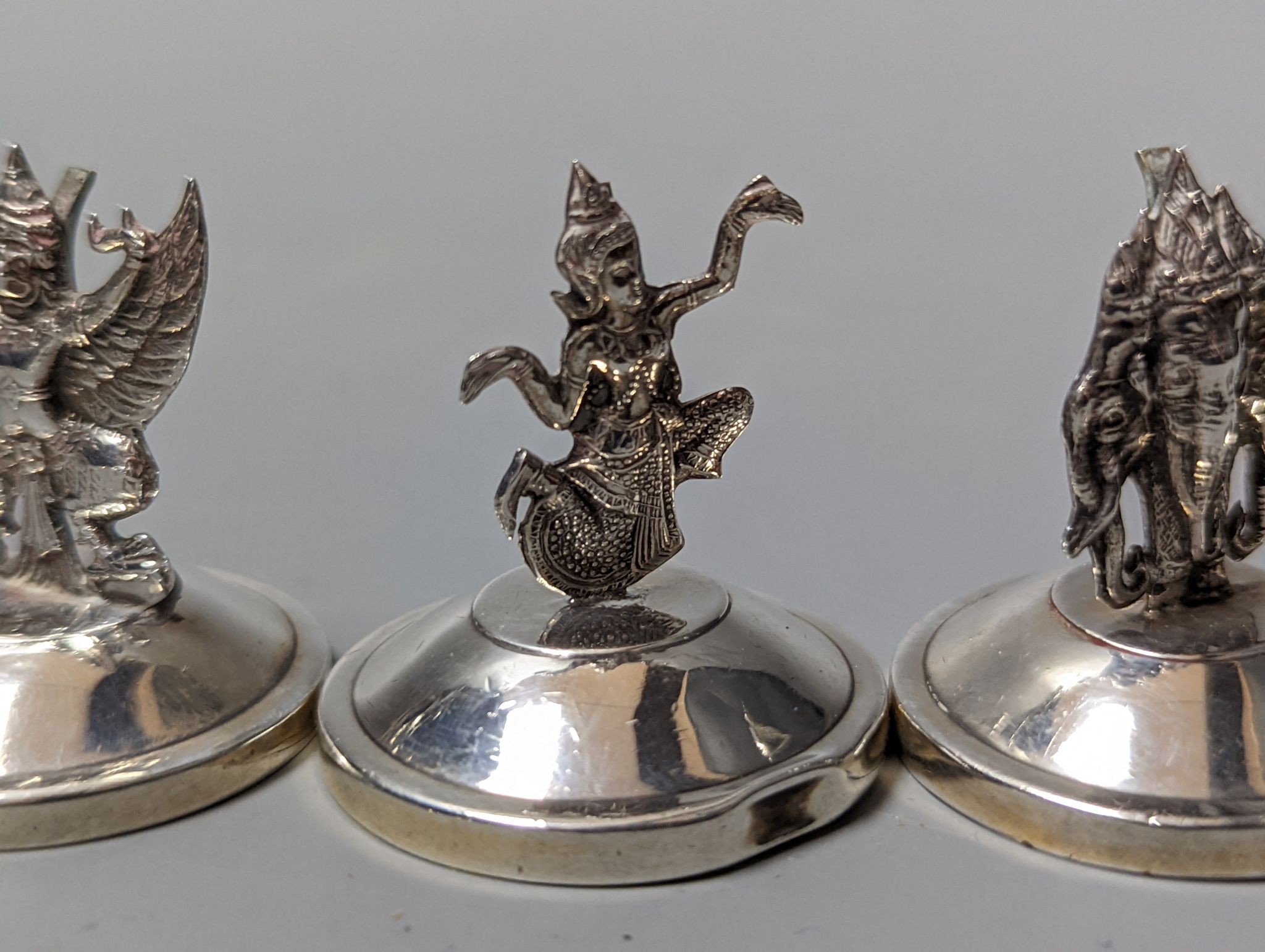 Sixteen assorted Siamese sterling mounted menu holders, modelled with figures, elephant, etc. - Image 16 of 17
