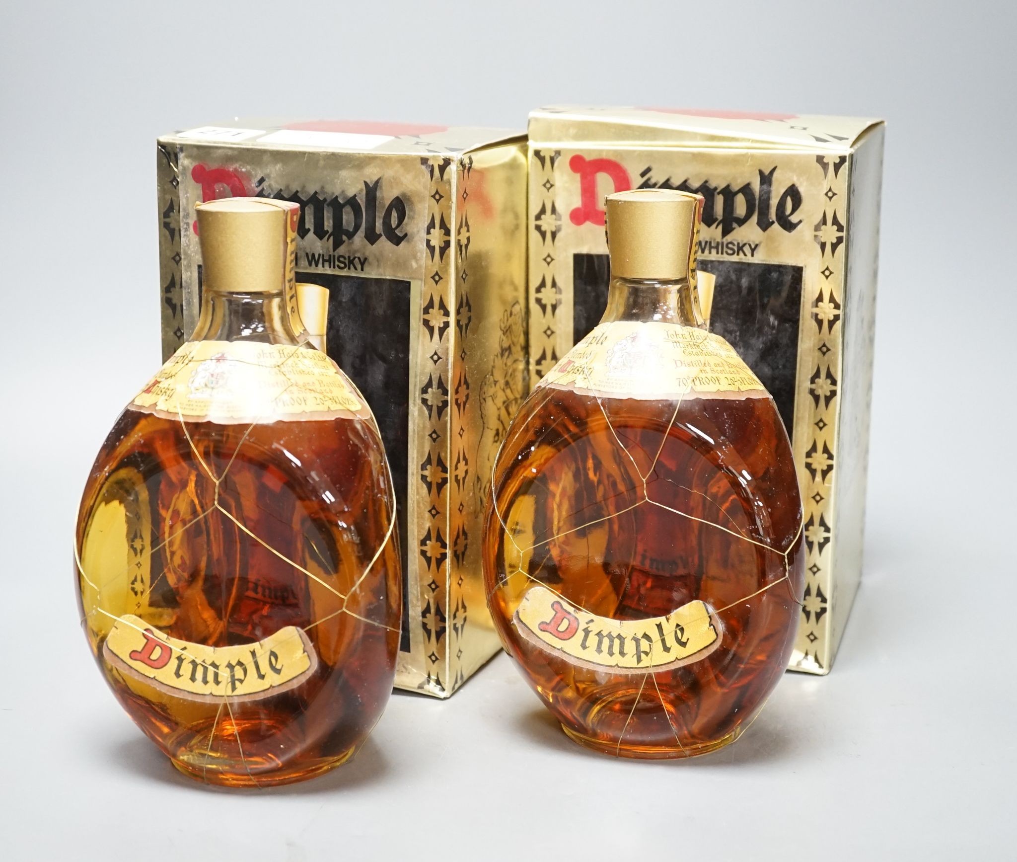 Two boxed bottles of Dimple Scotch whisky.