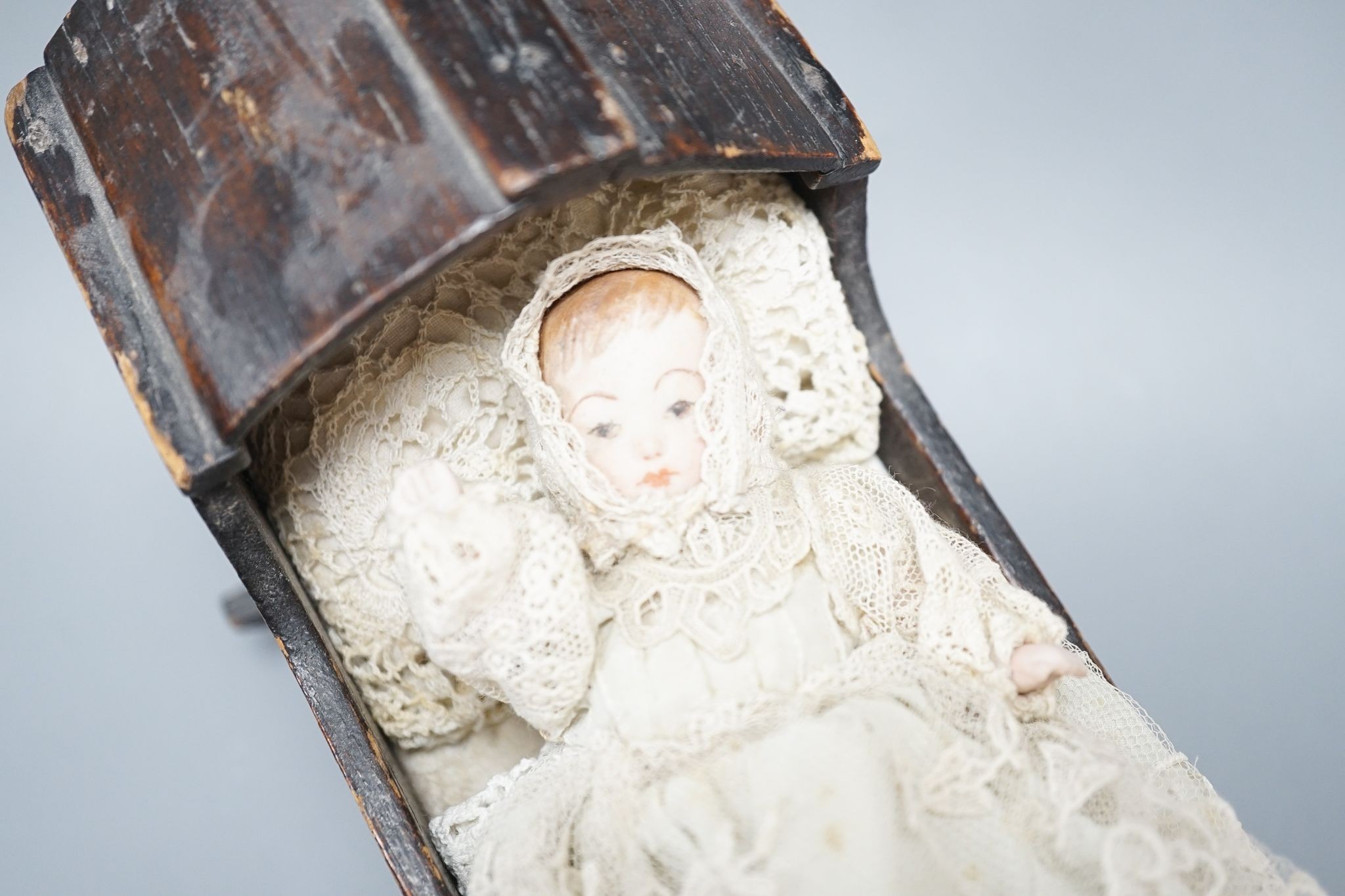 A collection of miniature bisque dolls and another larger doll in a wooden cradle, 11 dolls in - Image 3 of 8