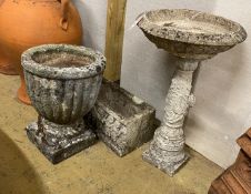 A reconstituted stone circular bird bath and two planters, largest 68cm