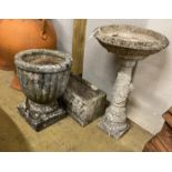 A reconstituted stone circular bird bath and two planters, largest 68cm