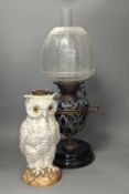 A Doulton Lambeth stoneware oil lamp and a German porcelain’owl’ lamp base,Oil lamp 54 cms high