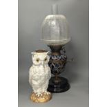 A Doulton Lambeth stoneware oil lamp and a German porcelain’owl’ lamp base,Oil lamp 54 cms high