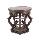 A Chinese hardwood stand, 19th century,the circular dish top above a fretted frieze, on four