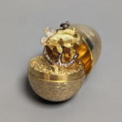 A 1970's textured silver gilt surprise egg by Stuart Devlin, opening to reveal a ship's anchor