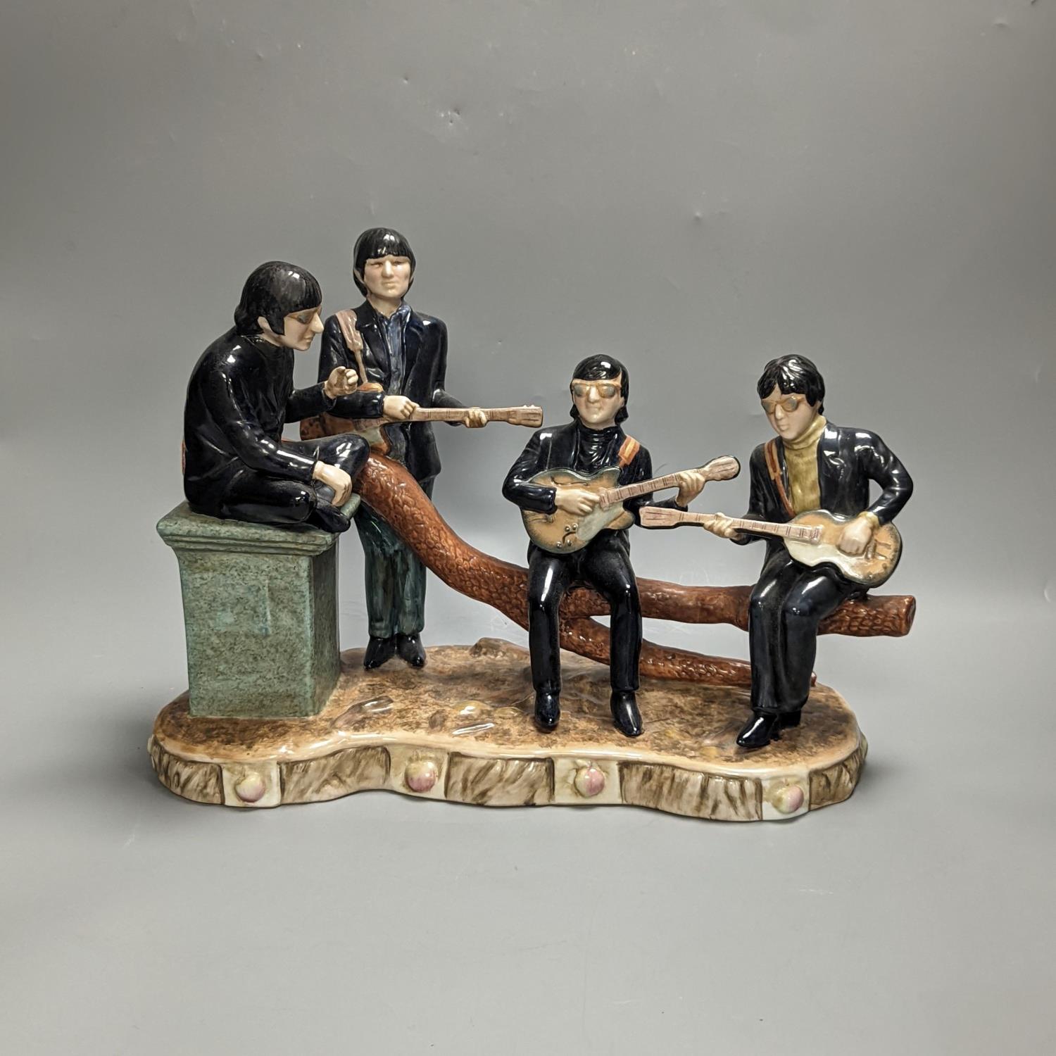 A large pottery figure group The Legends of Rock & Roll, The Beatles at Hyde Park 37cm long