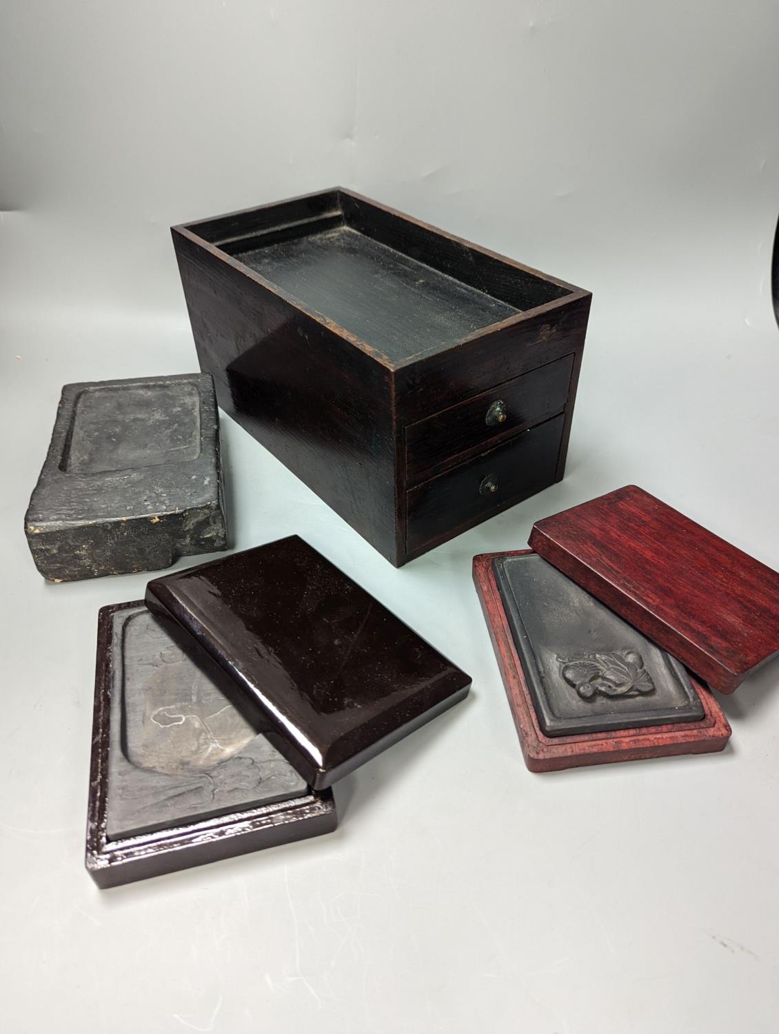 Three Chinese ink-stones, two in fitted boxes and a Japanese writing box,box 26 cms deep 14-5 wide.