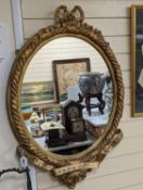 A Victorian gilt and composite mirror,,99 cms high.