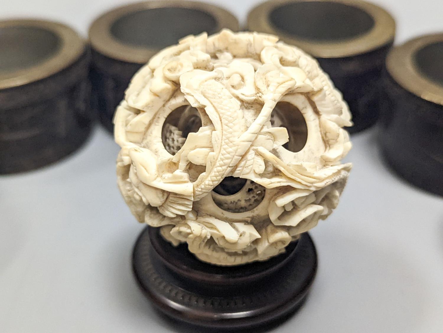 A Chinese ivory concentric puzzle ball, 6 Chinese coconut and brass mounted napkin rings. - Image 2 of 6