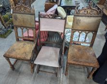 A pair of Gothic style carved walnut and leather side chairs together with an Edwardian beech