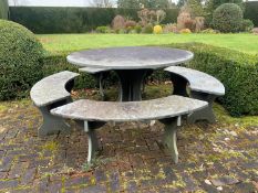 A heavy slate circular topped garden table, diameter 125cm, height 79cm together with four