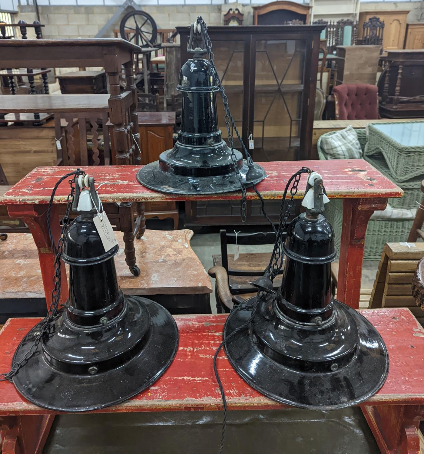 A set of three Continental black enamelled industrial style ceiling shades, height including