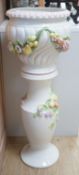 A modern Italian pottery jardiniere and stand, with floral and fruit decoration,104 cms high.