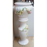 A modern Italian pottery jardiniere and stand, with floral and fruit decoration,104 cms high.