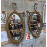 A pair of Edwardian Adam design oval giltwood and gesso wall mirrors, width 43cm, height 80cm