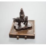 A small Chinese bronze seal of an immortal riding a bull and a Tibetan prayer case 9cm