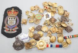 A quantity of cap badges, buttons and badges