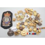 A quantity of cap badges, buttons and badges