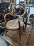 A near pair of early 20th century beech bentwood childs elbow chairs