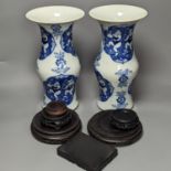 A pair of Chinese blue and white vases on stands and 6 further wood stands. Vases 35cm