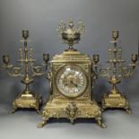 A 19th century French ornate brass clock garniture including a pair of 3 branch candelabraClock 42