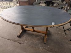 A French oval fruitwood Vendange wine tasting table with later painted top, length 174cm, depth