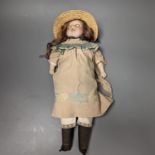 An Armand Marseille 370 bisque headed doll, wearing a basket weave boater and brown embroidered