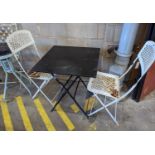 A square metal folding bistro table, width 60cm, height 71cm, together with two metal chairs