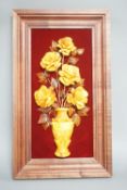 A carved amber panel from the Hermitage Museum shop, St Petersburg, roses in a vase. 49x39cm