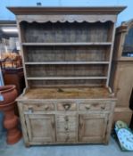 An early 19th century pine dresser with boarded rack, width 141cm, depth 49cm, height 206cm